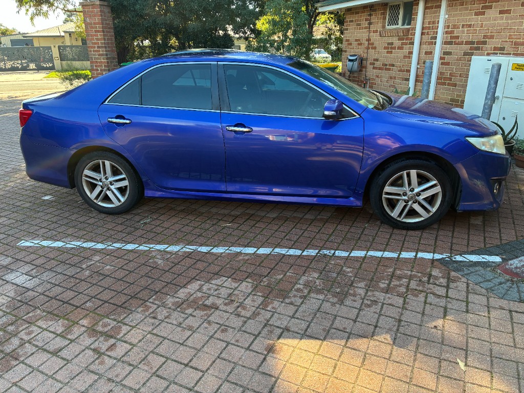 Side profile — blue Camry Atara S